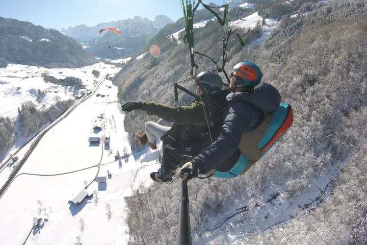paragliding over the snowy mountains